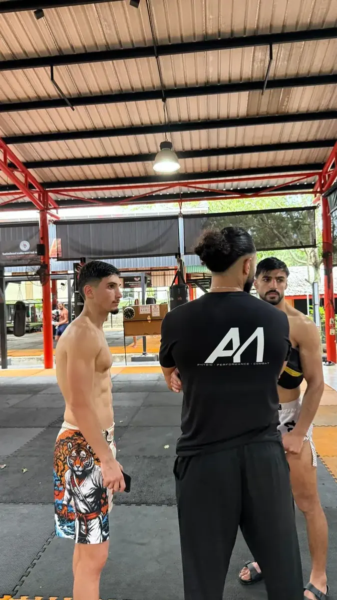 Physio coach preparing combat athletes during training
