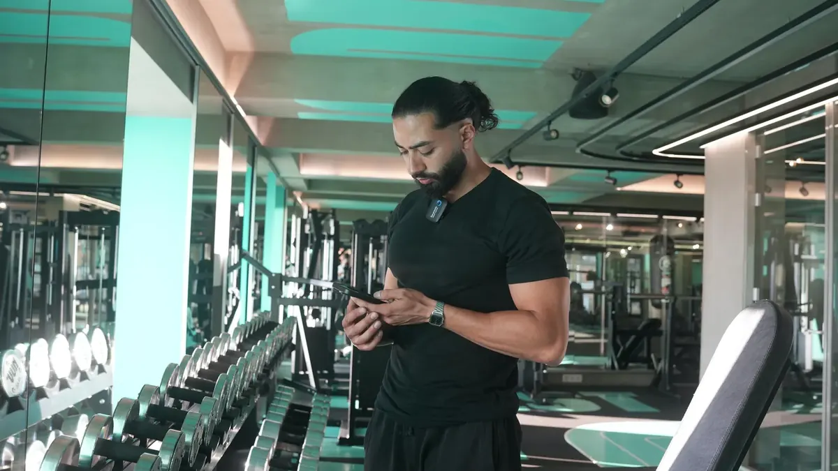 Physio coach reviewing client details in a gym environment